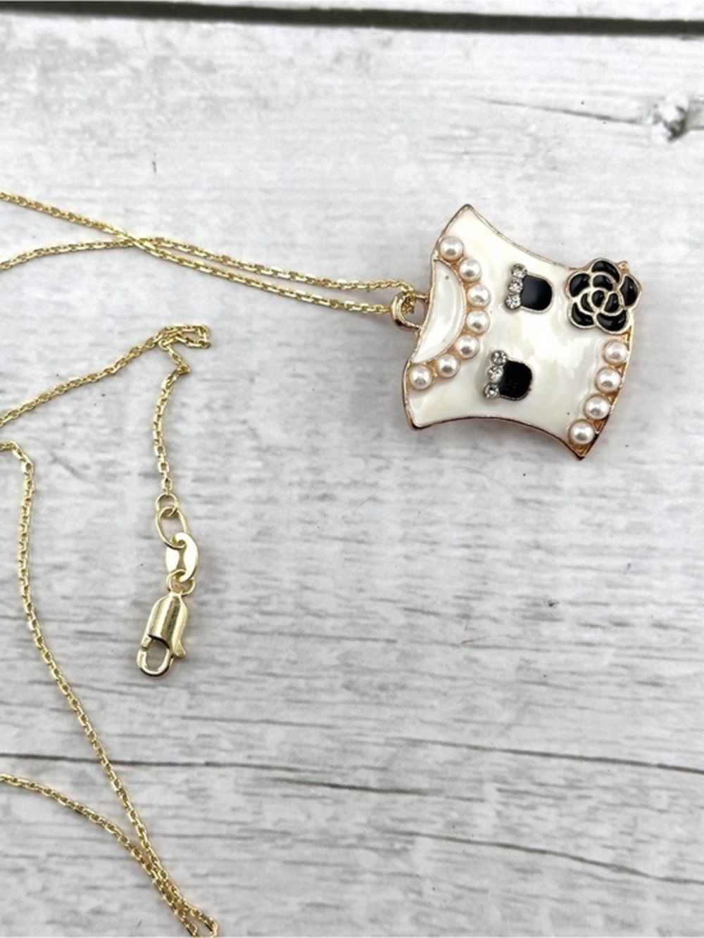 Lovely necklace with Louis Vuitton white and black pendant.